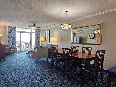 Dining area with a textured ceiling, crown molding