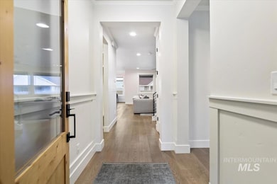 Corridor featuring light wood-style floors, recessed lighting, and ornamental molding