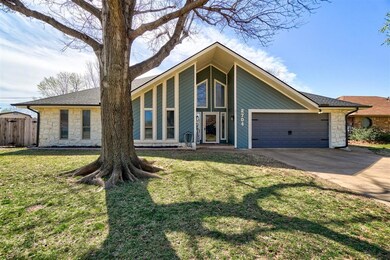 Single story home with a garage and front lawn
