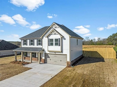 View of front of property with covered porch, driv