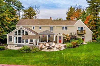 The backyard kitchen and fire pit is...
