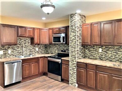 Really updated kitchen with lot of tile work, stainless appliances, refrigerator is just to the right of the picture. Lux vinyl plank flooring throughout or ceramic plank tile.