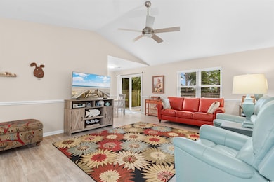 Living area featuring wood finished floors, a ceiling fan, and high vaulted ceiling