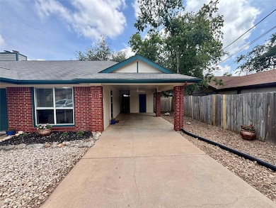 View of front facade with concrete driveway, bric