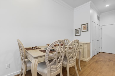 Dining room featuring ornamental molding, light wood finished floors, and recessed lighting