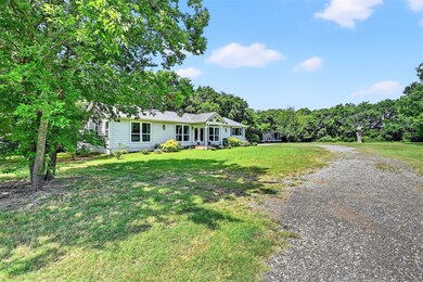 Ranch-style house featuring driveway and a front yard