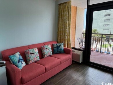 Living room with wood finished floors, healthy amount of natural light, and a wall mounted air conditioner