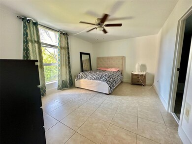 Fully tiled with upgraded baseboards and fan