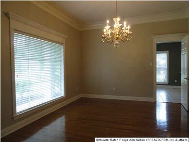 Gleaming wood floors, a picture window and crown m