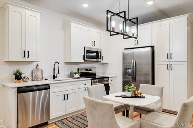 Kitchen with white cabinets, decorative light fixt