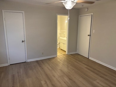 Unfurnished bedroom with light wood-style floors and a ceiling fan