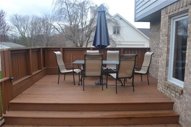 Top level of deck with space for entertaining and privacy wall.