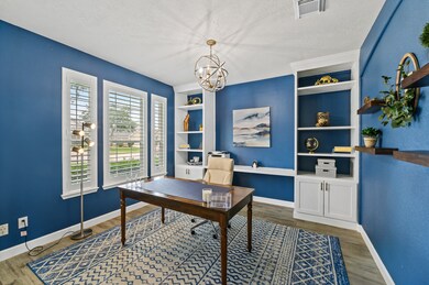 This home lacks no upgrades!  All windows on the front of the home boast trendy plantation shutters.  Fall in love with this office's custom built in shelving, and incredibly trendy new lighting fixtures.