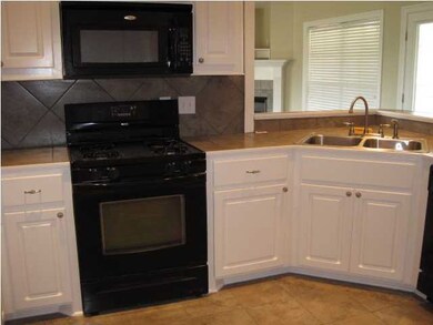 view of sink area which looks into den