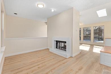 Unfurnished living room featuring a textured ceili