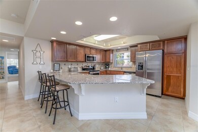 Gourmet kitchen has granite counters, lots of beautiful wood cabinets, pantry & breakfast bar!