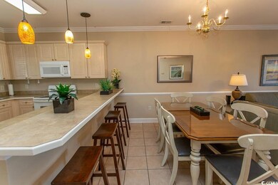 Dining space with ornamental molding, light tile p