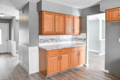 The kitchen has new countertops and tile backsplas