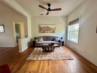 Living room with wood finished floors and a ceiling fan
