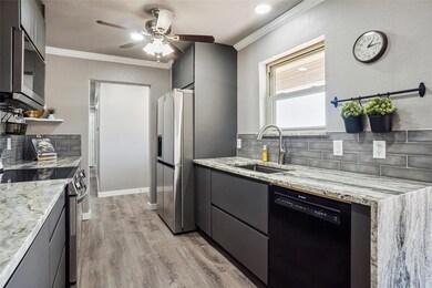 Kitchen with sink, crown molding, stainless steel 