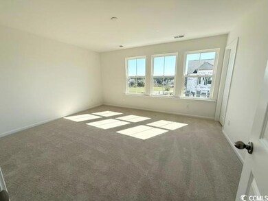 Carpeted spare room featuring baseboards