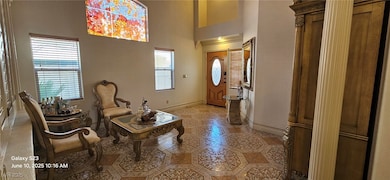 Foyer with light tile patterned floors and a tower