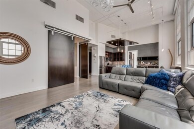 Living room with a towering ceiling, track lightin
