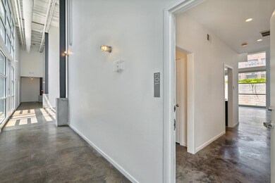 Corridor featuring concrete floors