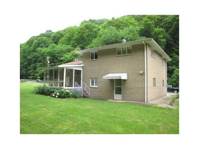 Exterior Back. The 3 season room room overlooks th