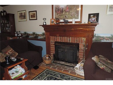 Living room with masonry fireplace and insert