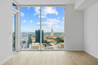 Unfurnished room featuring baseboards, a view of 
