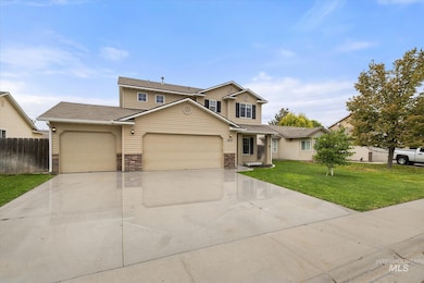 Traditional-style house with an attached garage, concrete driveway, stone siding, and roof with shingles