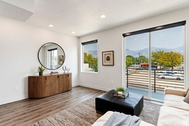 Living room with a mountain view, wood finished floors, recessed lighting, and a textured ceiling MODEL HOME