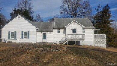 Back of house featuring a lawn and ac unit