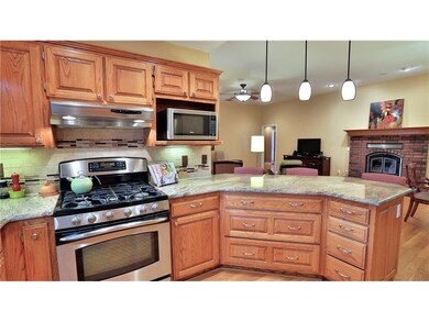 This recently updated kitchen features SS appliances and granite countertops.