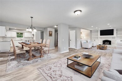 Open living/dining/kitchen areas open on to the upper-level sun room and make a great space for entertaining.