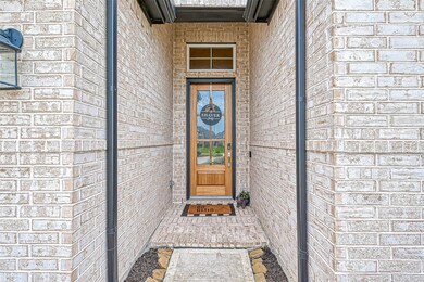 Fully bricked entry with wooden front 6 paneled glass door & transom window. Side bullrock and stone pavers set up a neat and clean appearance that continues throughout this fine property! Welcome inside....