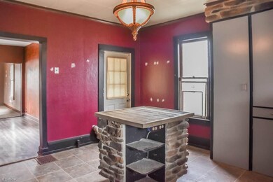 The kitchen has a center island with stone surroun