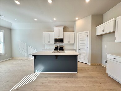 The quartz countertops, walk-in pantry, and stainless steel appliances provide the perfect combination of style and functionality for a modern and efficient living experience.
