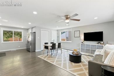 Living area with recessed lighting, wood finished floors, and a ceiling fan