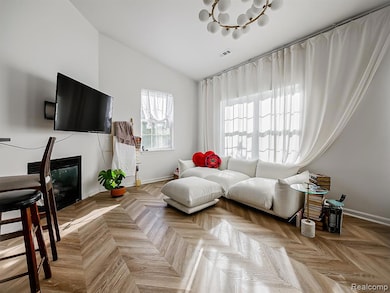 Living room with a glass covered fireplace and a chandelier