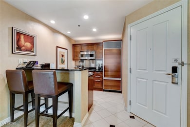 Kitchen featuring paneled fridge, a breakfast bar