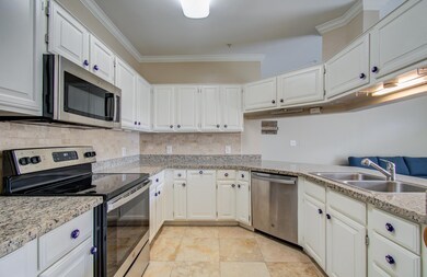 Kitchen features modern stainless steel appliances