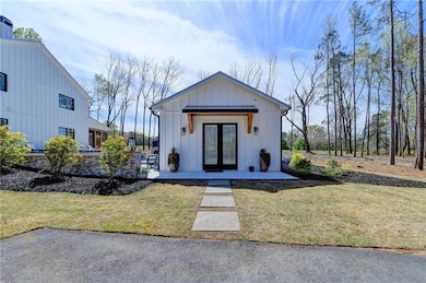 Modern inspired farmhouse featuring french doors, 