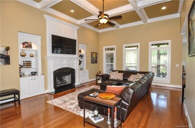 Coffered Ceiling in great room and fireplace. Open to kitchen and breakfast room.