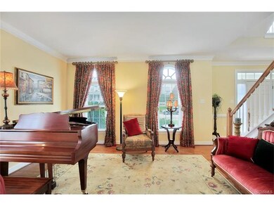 The parlor features hardwood floors and Palladian 