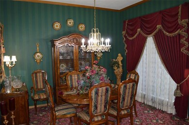 Dining room with carpet floors, a notable chandeli