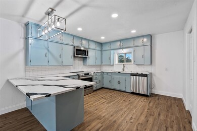 Kitchen featuring sink, tasteful backsplash, decor