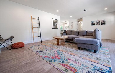 Living room featuring wood finished floors, baseb