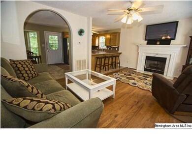 Living room featuring hardwoods, archway, marble f
